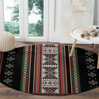 Round black folk-pattern carpet with red, green, and white geometric stripe center panel