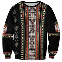 Black crewneck sweatshirt with vertical folk stripe and red diamond panel, banded cuffs