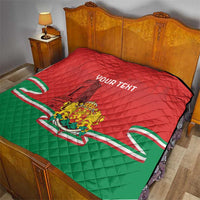 Red and green quilt on bed with Bulgarian crest, monument silhouette, and custom text