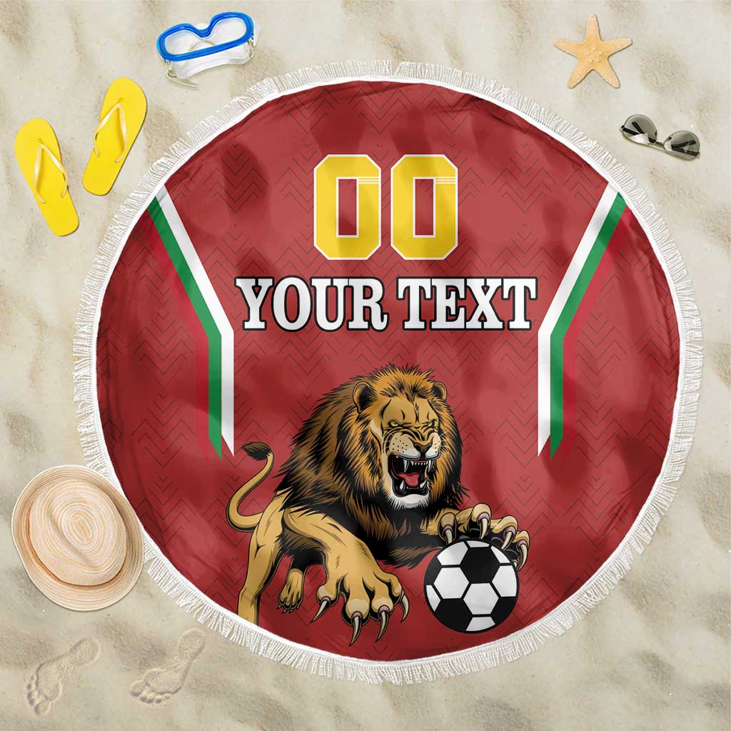 Red circular beach blanket with lion mascot and soccer ball, white fringe edge