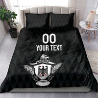 Black bedding set with two pillows, eagle crest and “00 YOUR TEXT” print on comforter.