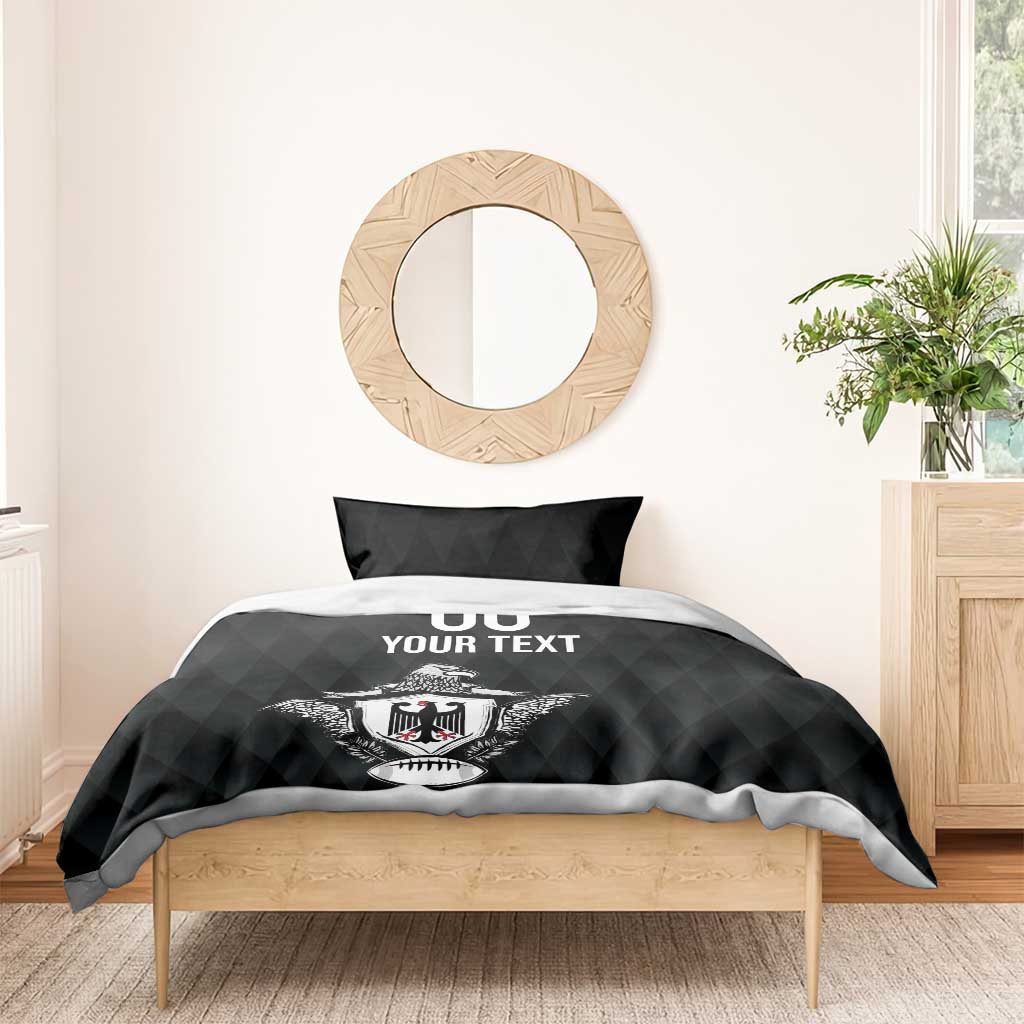 Black bedding set with eagle crest and “00 YOUR TEXT” on duvet, matching pillow shams.