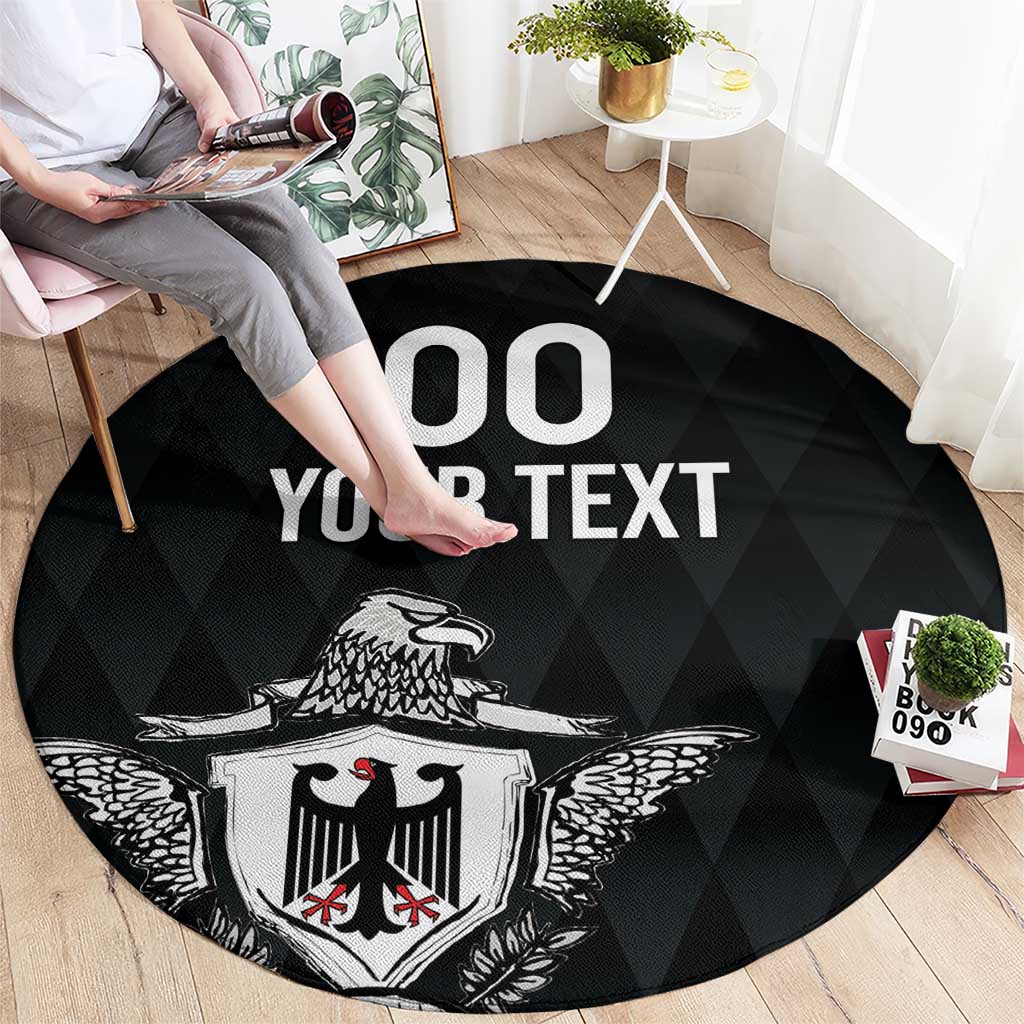 Black round rug with eagle crest and 'OO YOUR TEXT' text, angled view