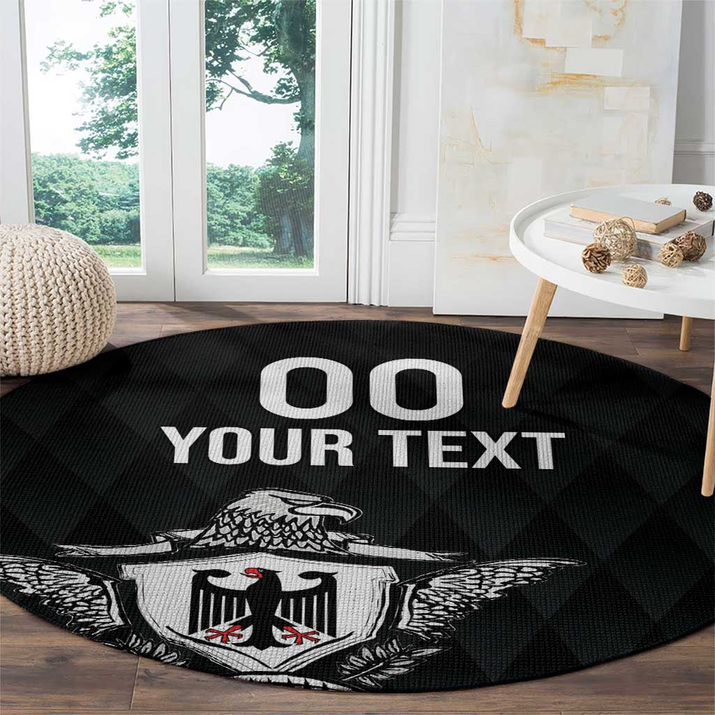 Black round rug with eagle crest and 'OO YOUR TEXT' text on wood floor