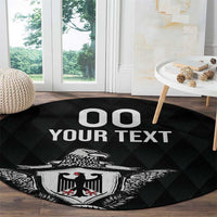 Black round rug with eagle crest and 'OO YOUR TEXT' text on wood floor