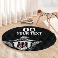 Round black rug with eagle crest and 'OO YOUR TEXT' graphic under chair
