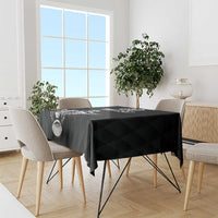 Black rugby tablecloth covering a dining table with geometric diamond pattern