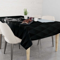 Black rugby tablecloth draped over a rectangular table with matching design print
