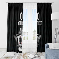 Black curtains with eagle crest and custom text, mounted on a straight curtain rod.