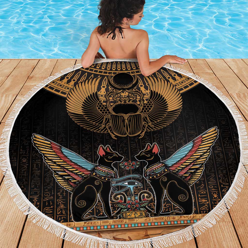Round black beach blanket with gold scarab beetle wings design and white fringe edge
