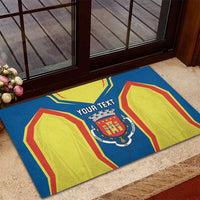 Personalized rubber doormat, blue graphic with crest and yellow side shapes, red outlines