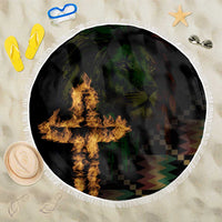 Round black beach blanket with white fringe and flame graphic over dark checkered design