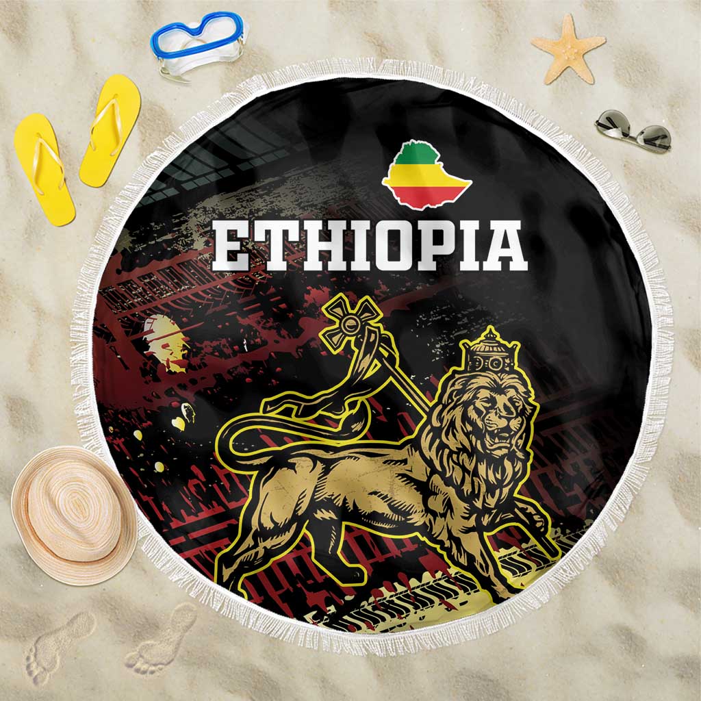 Black round beach blanket with white fringe, Ethiopia lion graphic and text