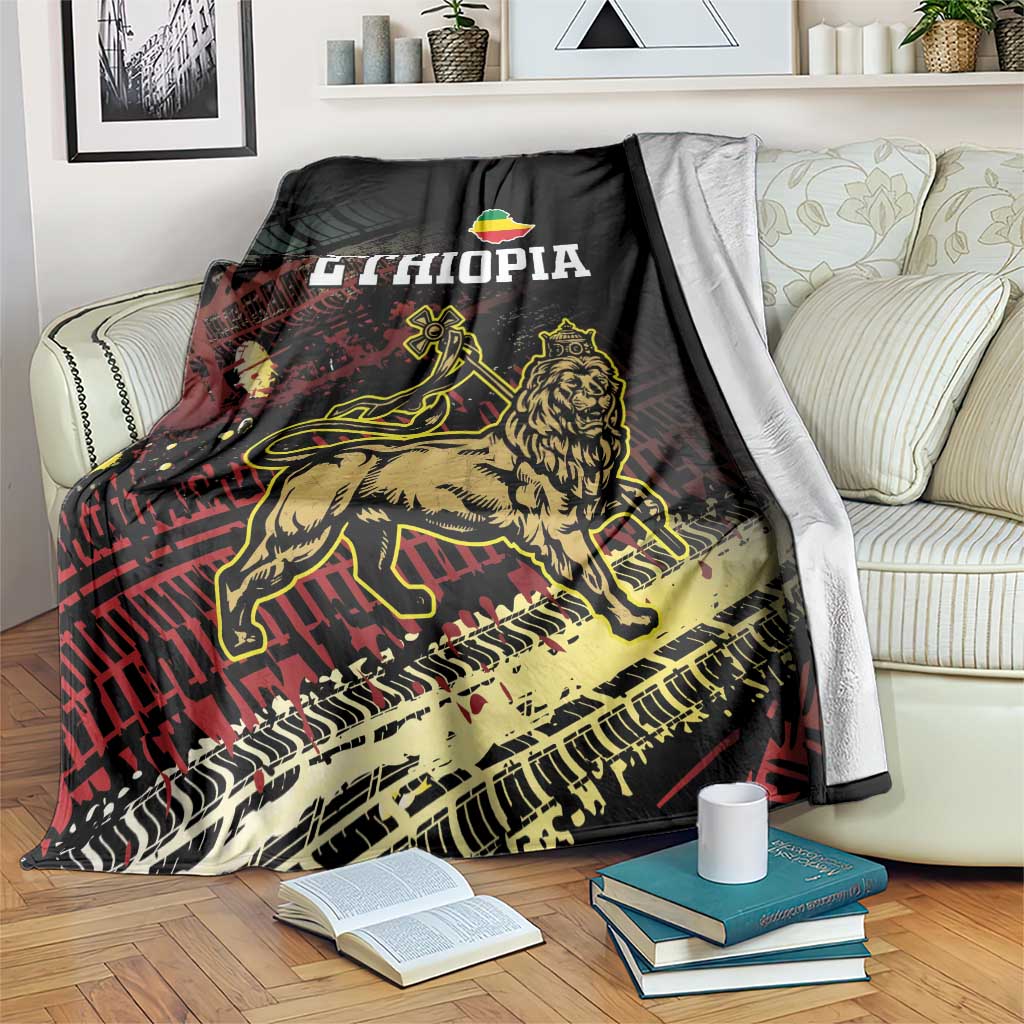 Meskel Ethiopia blanket draped on sofa, black with lion of Judah graphic and ETHIOPIA