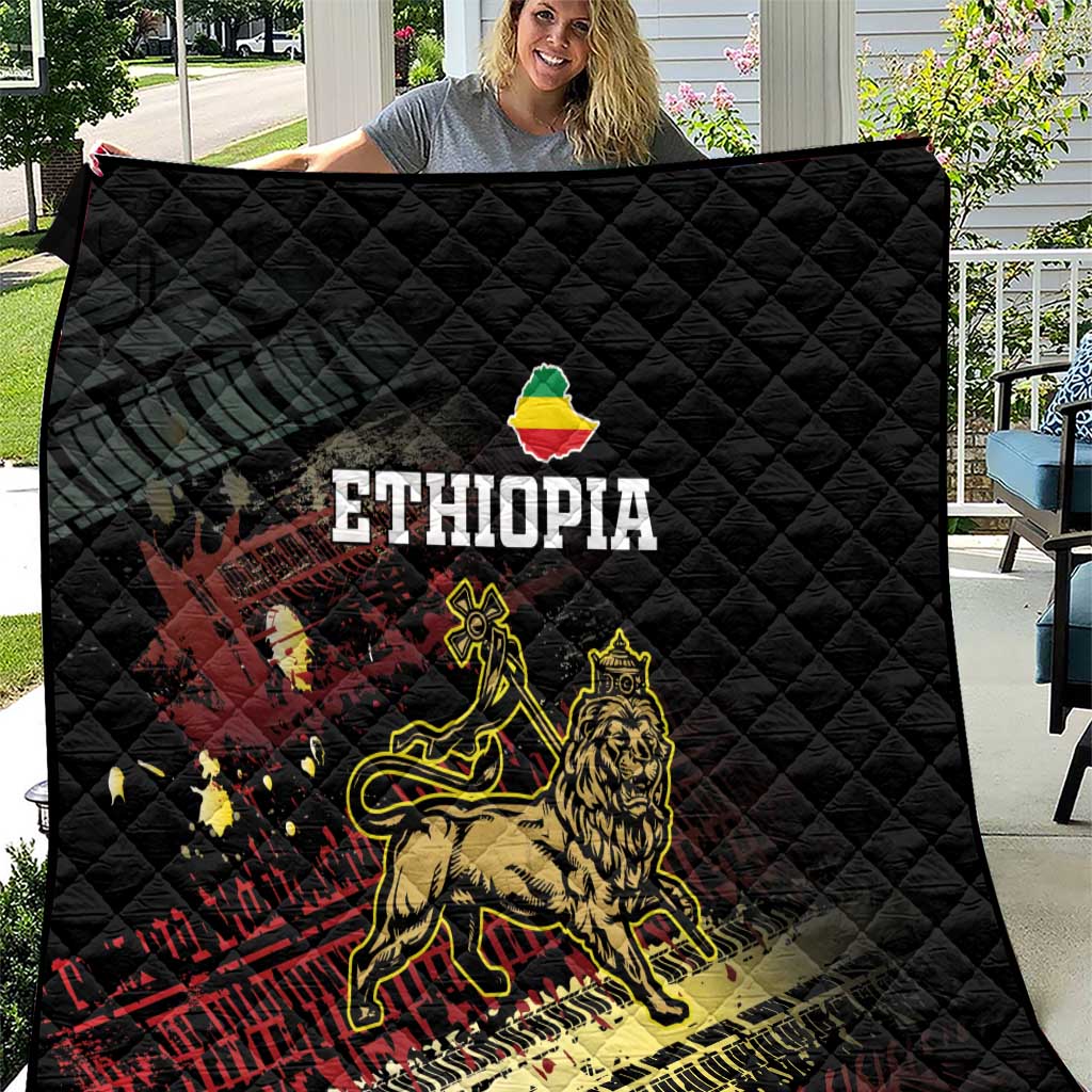 Black Ethiopia quilt with quilted diamond pattern and Lion of Judah graphic, multicolor print.