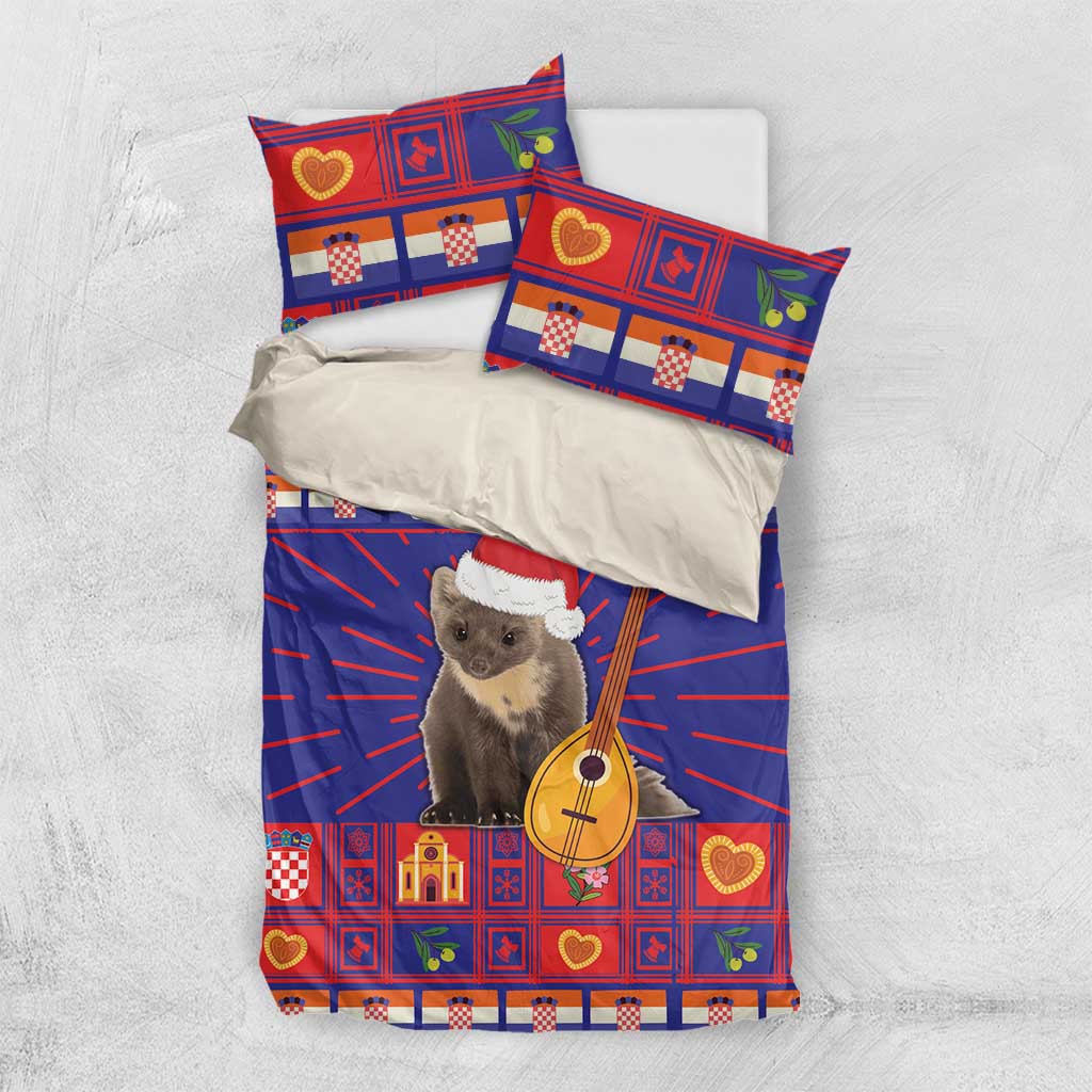 Christmas bedding set laid flat: blue and red patterned duvet with two pillowcases featuring cat and guitar