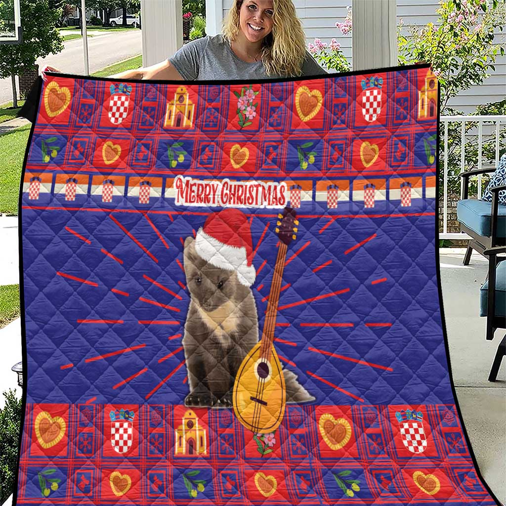 Christmas quilt in blue and red with gray animal and guitar amid heart and plaid blocks
