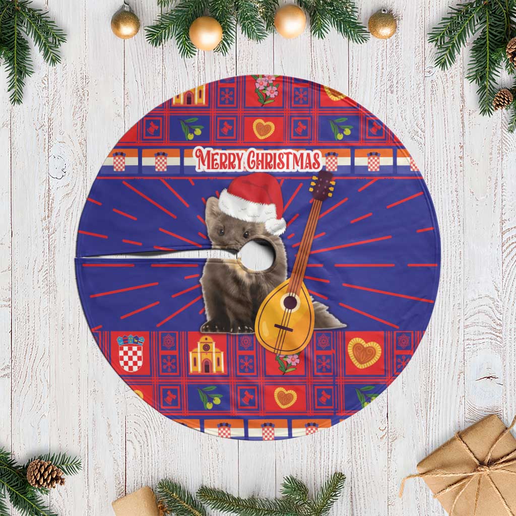 Red Christmas tree skirt with blue fringe edge, cat holding a guitar and “Merry Christmas”