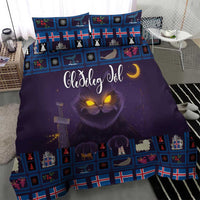 Purple Christmas comforter with blue Nordic border, glowing cat eyes, and decorative throw pillows
