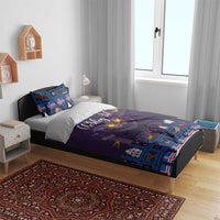 Purple and blue Christmas bedding set on bed with cat-face graphic and matching pillowcases