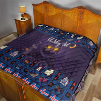 Purple quilt blanket on bed with blue Christmas cat border and moon glow