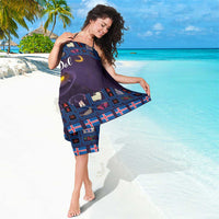 Purple beach sarong with blue window-grid pattern, cats, and holiday lettering