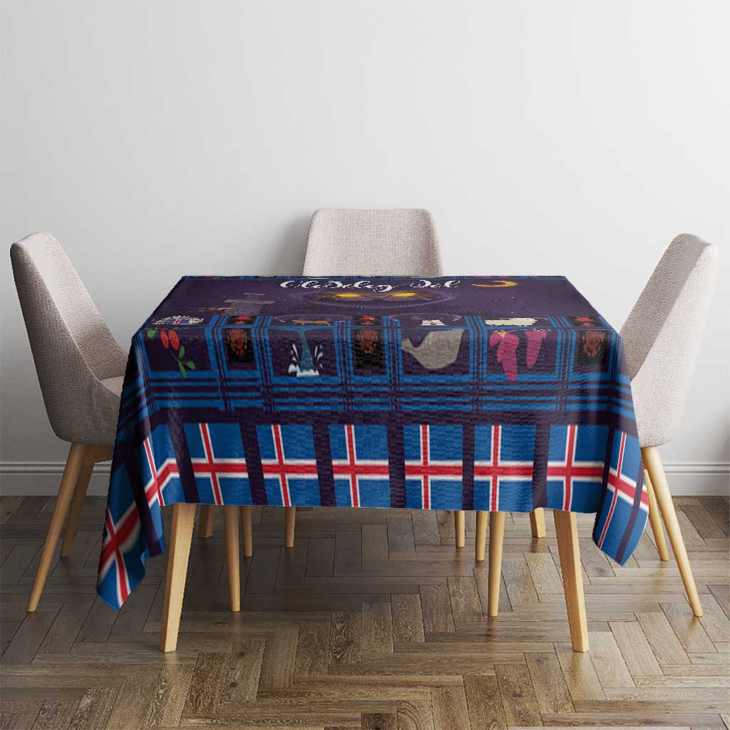Blue plaid Christmas tablecloth with purple cat artwork on tabletop