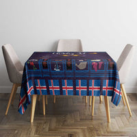 Blue plaid Christmas tablecloth with purple cat artwork on tabletop