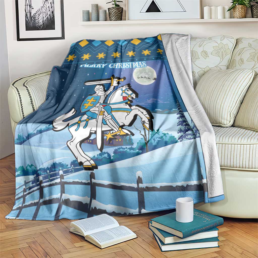 Blue blanket on sofa with 'Merry Christmas' text, knight on horseback, and fence motif