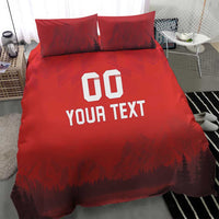 Red duvet set with 'DO YOUR TEXT' print and forest-mountain scene; two front pillows