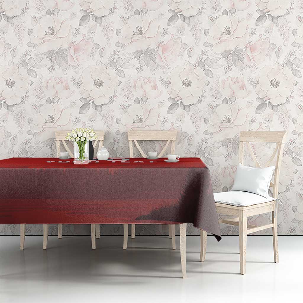 Red custom tablecloth with dark landscape graphic on a long dining table