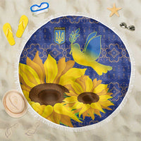 Round beach blanket with blue folk pattern, yellow sunflowers and dove graphic, white fringe