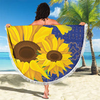 Round beach blanket with blue folk design, yellow sunflowers and dove, white tassel fringe