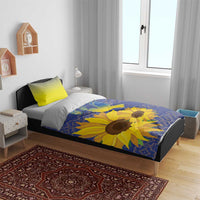 Blue sunflower duvet with lime-yellow pillows on bed, folk pattern and dove graphic