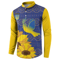 Blue and yellow button sweatshirt with dove, sunflower graphics, and folk pattern front