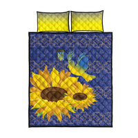 Quilt bed set with blue patterned comforter, yellow sunflower and dove, plus two yellow pillows