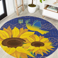 Blue round rug with yellow sunflowers, green dove, and folk geometric border