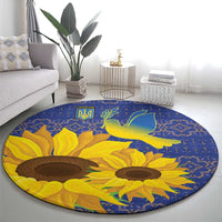 Blue round rug with large sunflower heads and green dove over geometric trim