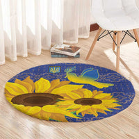 Blue round rug with sunflower pattern, green dove motif, and decorative border