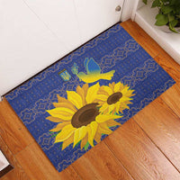 Blue rubber doormat with sunflower and dove peace design over decorative folk border