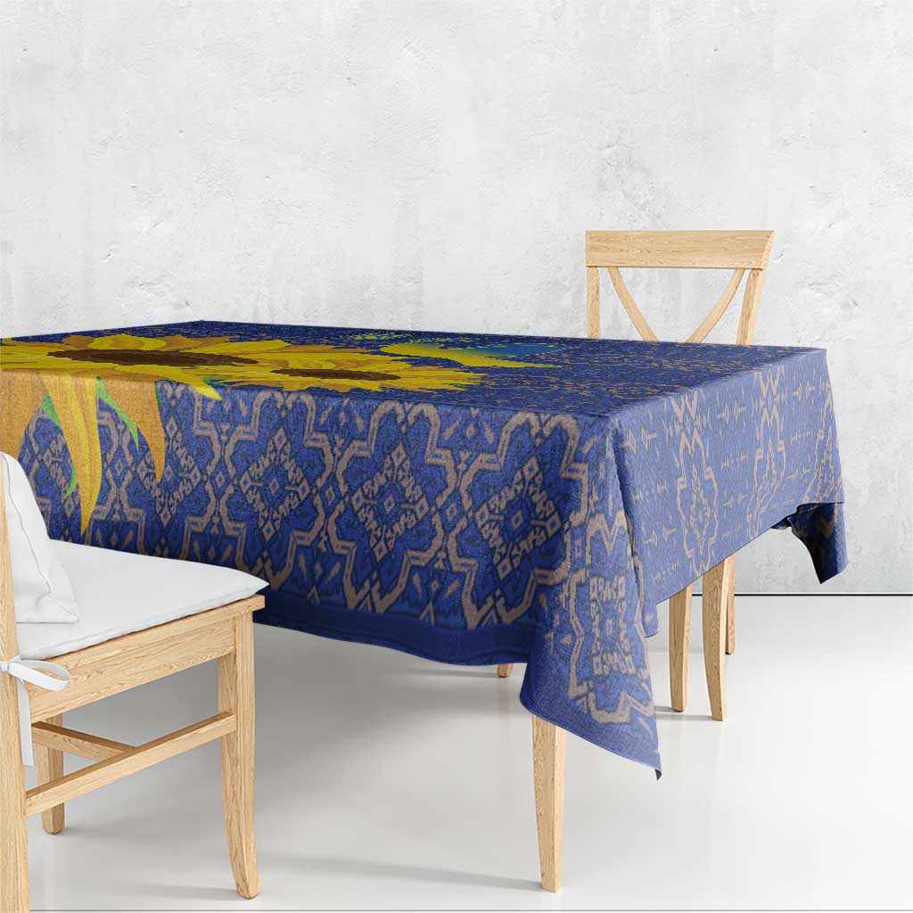 Blue folk tablecloth with geometric pattern and yellow sunflower detail