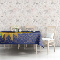Blue folk-pattern tablecloth with geometric border and yellow sunflower accents