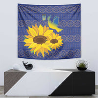 Blue tapestry with yellow sunflowers, white-and-gold dove, and folk geometric patterns