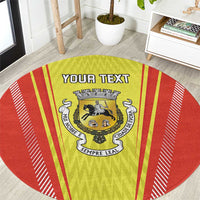 Round red and yellow rug with crest emblem and centered 'YOUR TEXT' banner