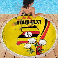 Yellow round beach blanket with white fringe, Uganda crowned crane design and 'YOUR TEXT' print.