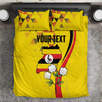 Yellow duvet cover and two pillowcases with Uganda map, crane graphic, and flowers