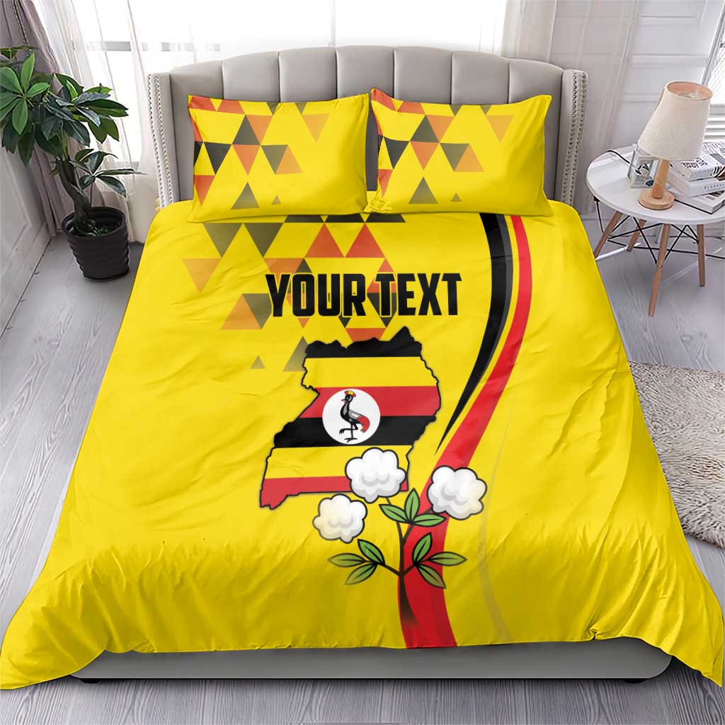 Yellow bedding set with duvet and two pillows; centered Uganda crest with 'YOURTEXT'