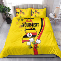 Yellow bedding set with duvet and two pillows; centered Uganda crest with 'YOURTEXT'