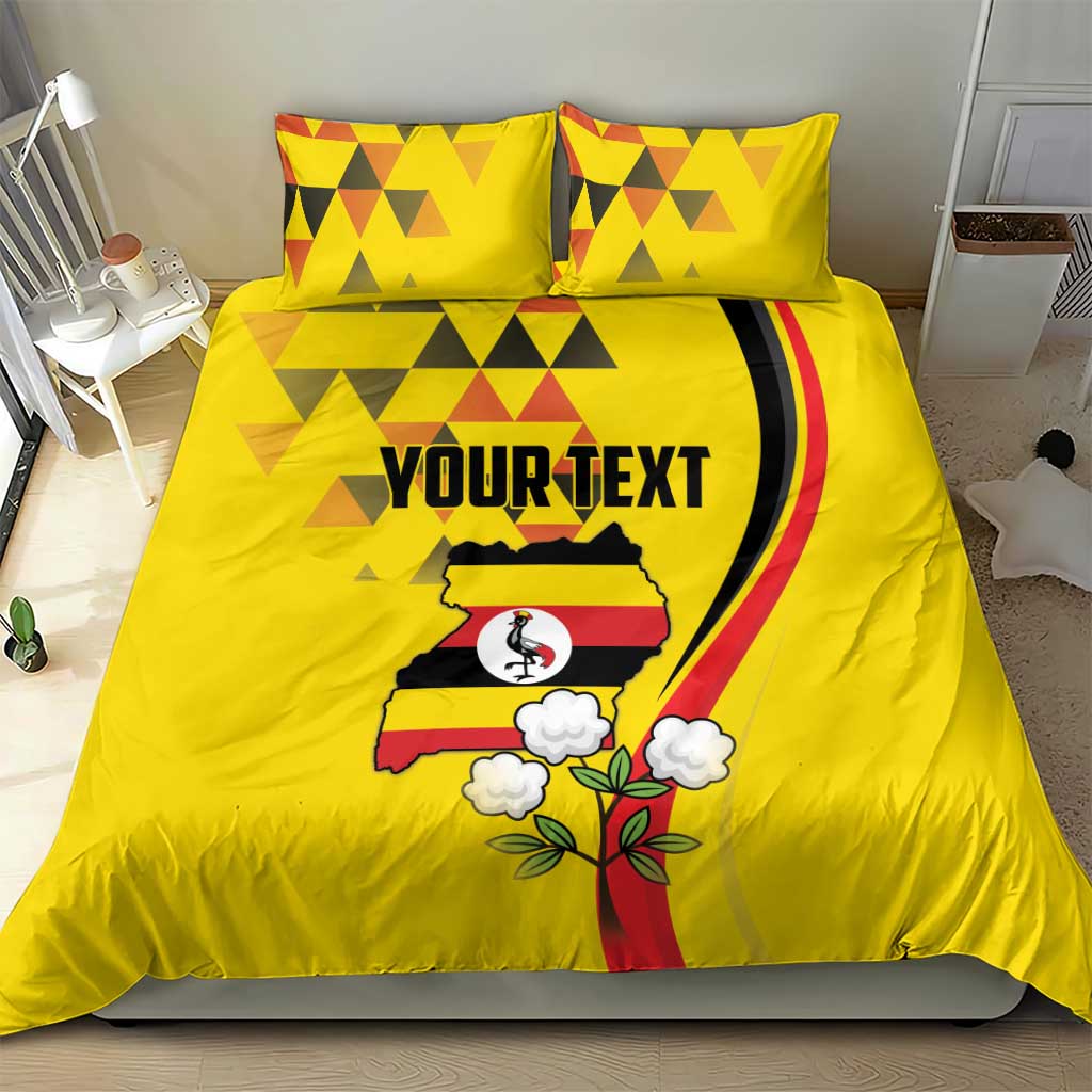 Yellow bedding set with duvet cover and two pillows; geometric pattern and Uganda crest