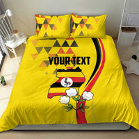 Yellow bedding set with duvet cover and two pillows; geometric pattern and Uganda crest